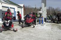 Photo of several people filling snowmobiles with gas - in Randolph